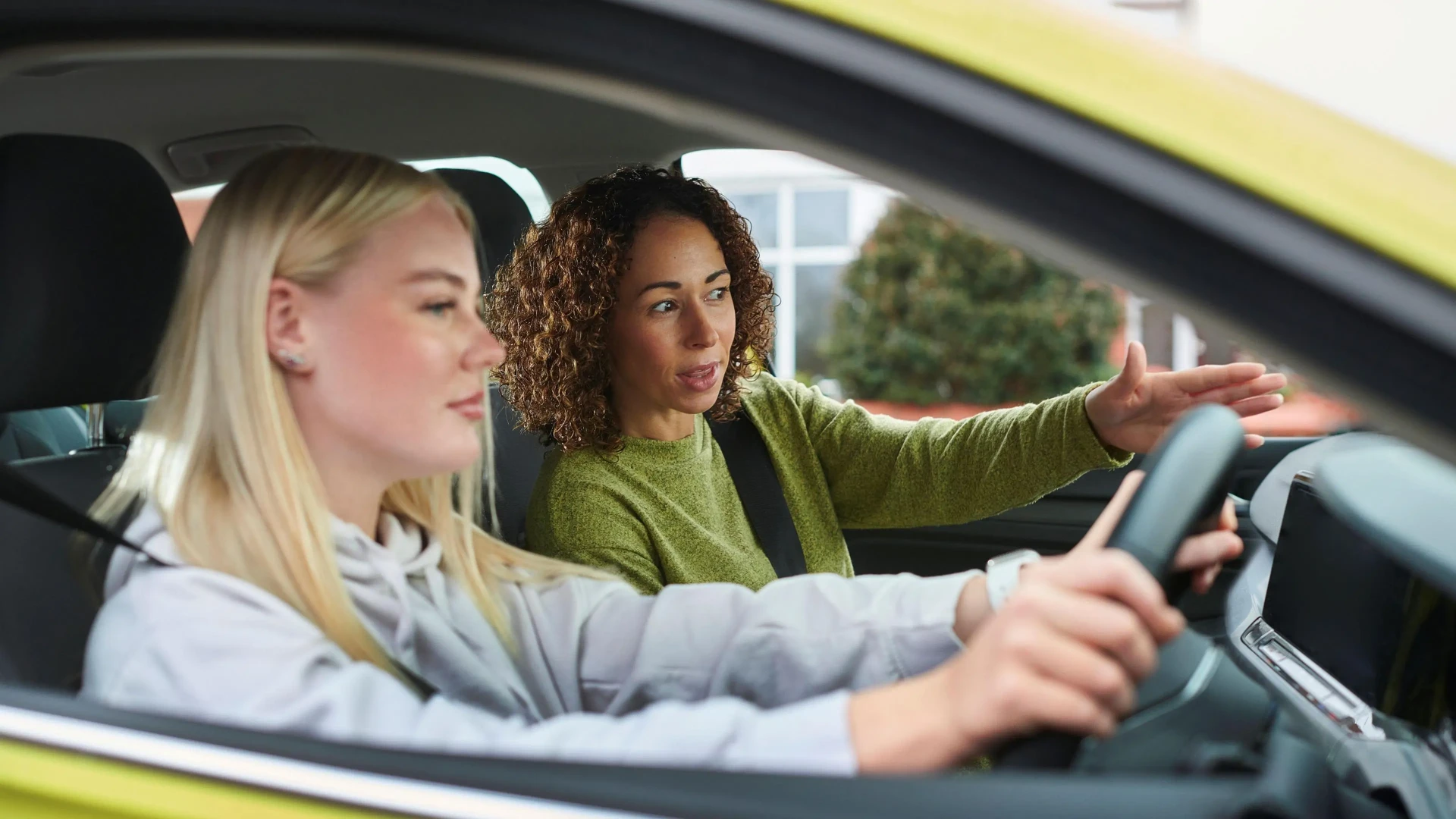 Learner driver with instructor in a car